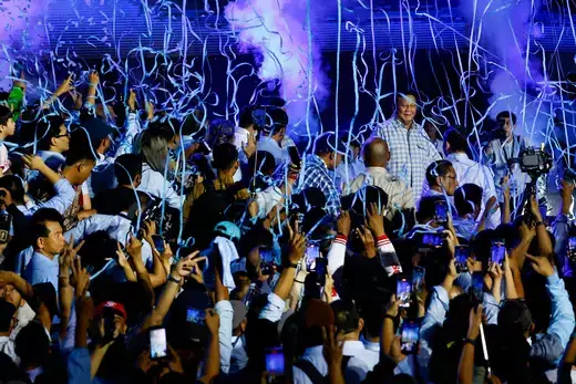 Suporters gather around Presidential candidate Prabowo Subianto as he claims victory after unofficial vote counts during an event to watch the results of the general election in Jakarta, Indonesia, February 14, 2024. 