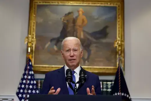 Biden as viewed standing behind a podium in the White House.