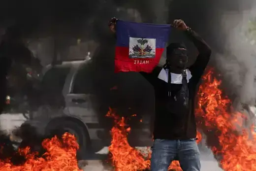 A protestor holds up a Haitian flag during a demonstration against Prime Minister Ariel Henry's government and insecurity in Port-au-Prince on March 1, 2024.