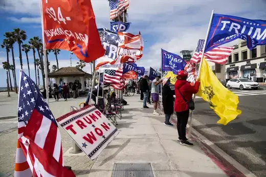 Supporters of Republican presidential candidate and former U.S. President Donald Trump gather on the street with Trump flags, ahead of Super Tuesday, in Huntington Beach, California, U.S.