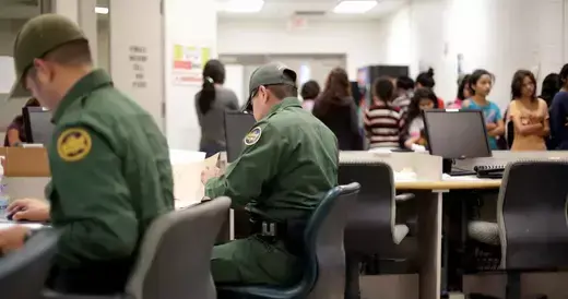 U.S. Customs and Border Protection agents work at a processing facility in Brownsville, TX. 