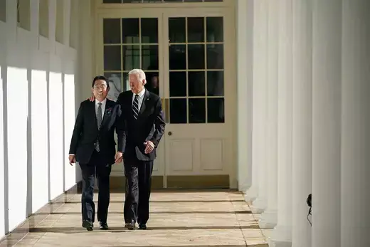 Prime Minister Kishida and President Joe Biden walking together in the White House Garden.