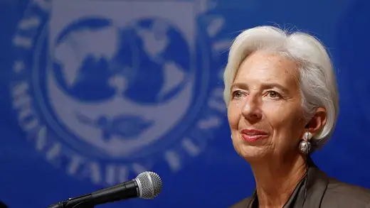 Christine Lagarde speaking with the IMF logo in the background.