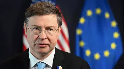 Portrait of Executive Vice President of the European Commission Valdis Dombrovskis with American and European Union's flags in the background.  