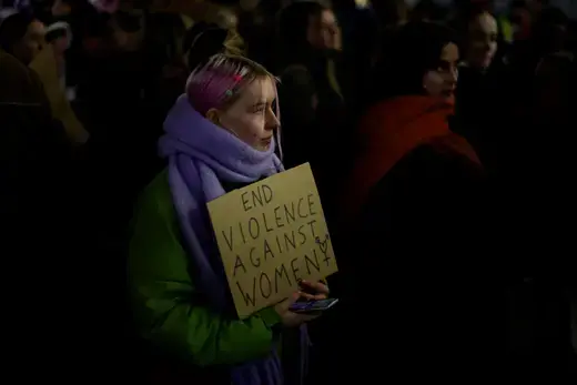 A woman holds a placard as people gather to demonstrate during the Reclaim the Night march to stop gender based violence, in Manchester, Britain, November 29, 2023. 