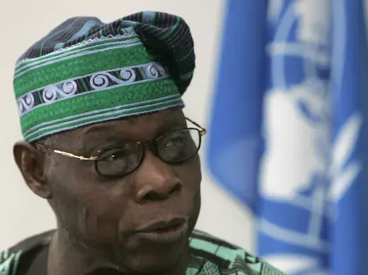 Nigeria's former president Olusegun Obasanjo is shown wearing a traditional Nigerian outfit in the color green. 