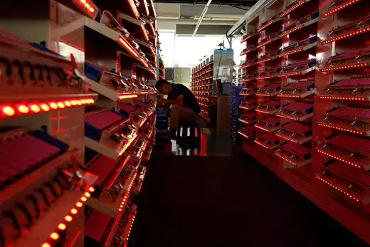 A worker inspects batteries for electric vehicles being manufactured at a factory in Dongguan, China. 