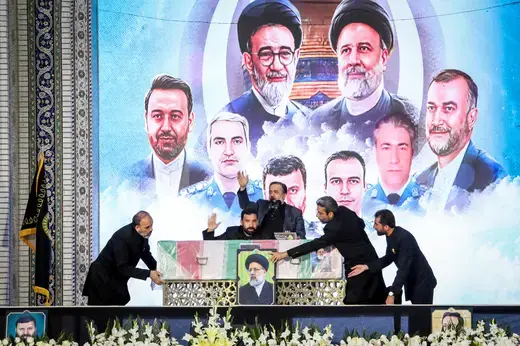 Staff handle the coffin of late Iranian President Ebrahim Raisi during his burial ceremony in the holy shrine of Imam Reza in Mashhad, Iran, on May 23, 2024.