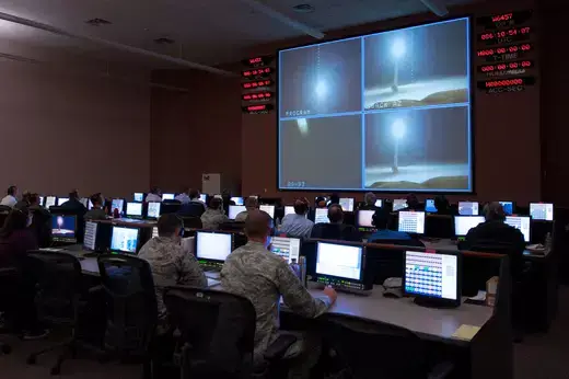 Three rows of members of the 576th Flight Test Squadron monitoring the Minuteman III Test.