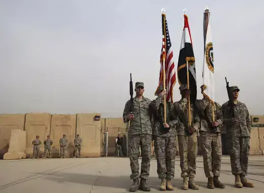 Members of the U.S. military retire its ceremonial flags signifying the end of their presence in Iraq at the Baghdad Diplomatic Support Center on December 15, 2011. 