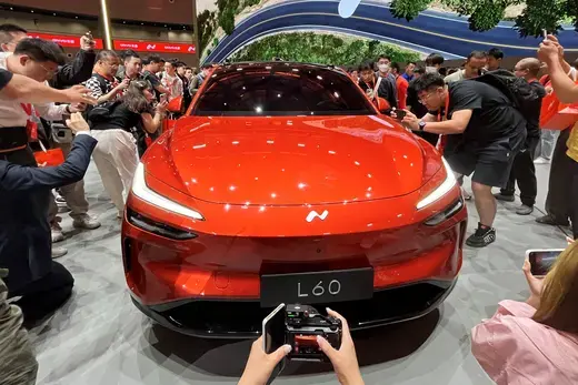 People look at the newly unveiled Onvo L60 SUV, the first vehicle of Chinese electric vehicle (EV) maker Nio's new lower-priced brand.
