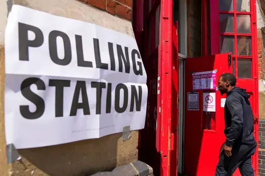 A man walks into a polling station to vote in UK elections, July 5, 2024.