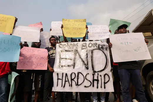 Demonstrators hold placards during a protest against the hike in price and hard living conditions in Ibadan, Nigeria on February 19, 2024.