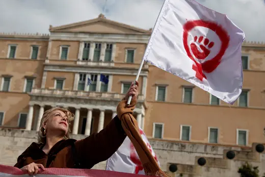 A woman waves a flag depicting a symbol of feminism during a march to celebrate International Women's Day in Athens March 8, 2014. 