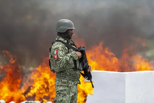 A soldier stands guard as over 850 kilos of drugs are burned in Monterrey, Mexico.