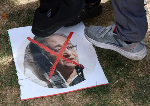 People step on an image as they react to the resignation of Bangladeshi Prime Minister Sheikh Hasina, in East London, Britain, August 5, 2024.