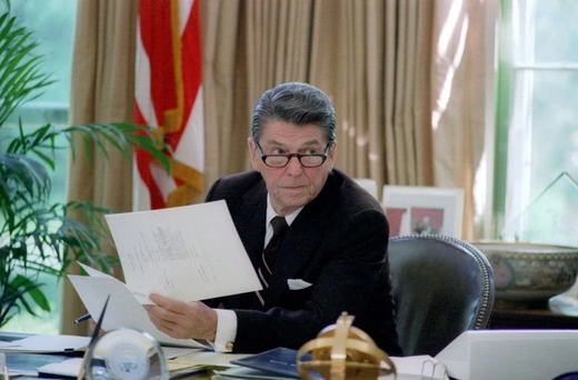 President Ronald Reagan at his desk in the Oval Office in Washington, DC. HUM Images/Universal Images Group/Getty Images