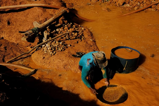 A Brazilian wildcat miner pans for gold at a wildcat gold mine in a deforested area of the Amazon rainforest.