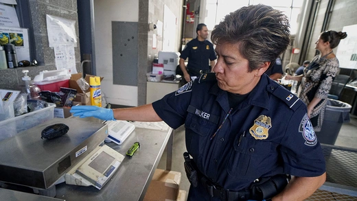 A U.S. Customs and Border Protection officer weighs a package of fentanyl in San Ysidro, California.