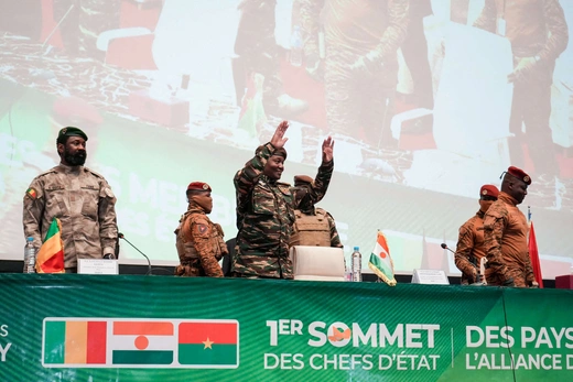 Niger’s junta leader Gen. Abdourahamane Tchiani reacts as Mali’s Assimi Goïta and Burkina Faso’s Capt. Ibrahim Traoré stand during the first ordinary summit of heads of state and governments of the AES on July 6, 2024 in Niamey, Niger.