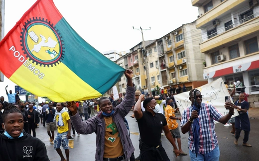 Protesters hold a PODEMOS flag during a nationwide strike to protest the provisional results of an October 9 election, in Maputo, Mozambique on October 21, 2024.