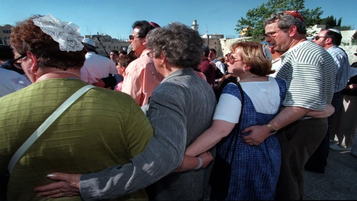 American Jews belonging to the Union of American Hebrew Congregations link arms as they hold a mixed male and female prayer session.