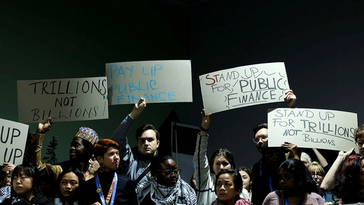 Activists hold placards during a protest action at the COP29 United Nations climate change conference, in Baku, Azerbaijan.