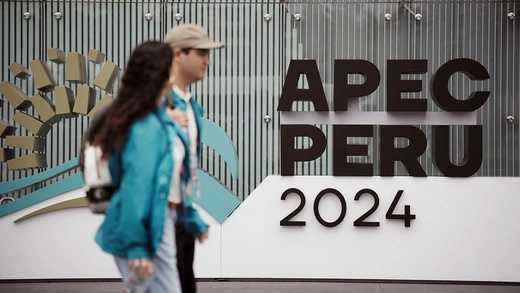 People walk in front of the venue of the Asia-Pacific Economic Cooperation (APEC) summit, in Lima, Peru November 12, 2024.