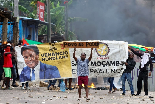 Protesters hold a banner with the face of Venancio Mondlane, independent candidate for the presidency of Mozambique during a "national shutdown" against the election outcome, in Maputo, Mozambique, on November 7, 2024.