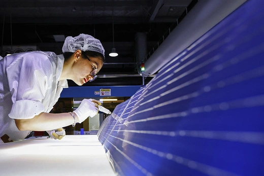 An employee works on photovoltaic modules destined for export at a factory in Sihong, China, on Sept. 3.