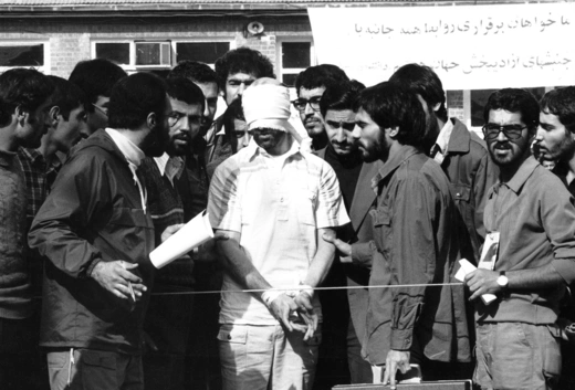 Iranian students display a blindfolded American hostage as they occupy the U.S. embassy in Tehran on November 11, 1979.