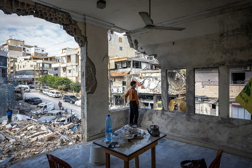 A boy stands inside his damaged house in Tyre, Lebanon, in November 2024.