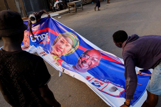 Young men prepare a banner of the presidential candidate of Ghana's ruling New Patriotic Party, Mahamudu Bawumia, ahead of the elections on December 7, in Accra, Ghana on December 2, 2024.