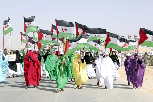 Sahrawi women attend a parade celebrating the fiftieth anniversary of the Polisario Front in Tindouf, Algeria.