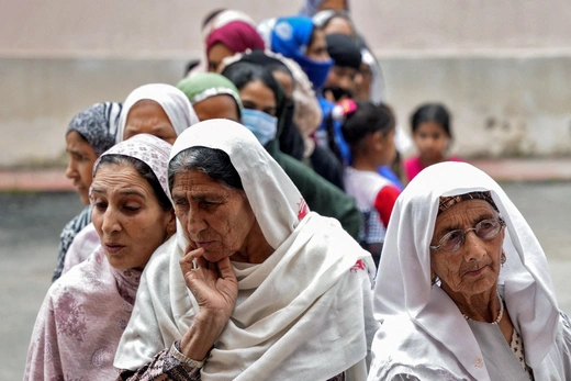 Women wait to cast their votes at a polling station during the fourth phase of India's general election in Srinagar May 13, 2024. 