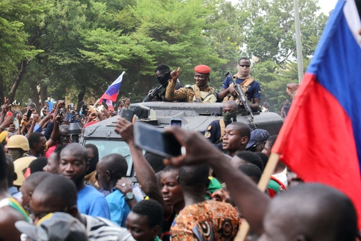 Burkina Faso's self-declared leader Ibrahim Traoré is welcomed by supporters holding Russian flags as he arrives at the national television station in Ouagadougou, Burkina Faso on October 2, 2022.