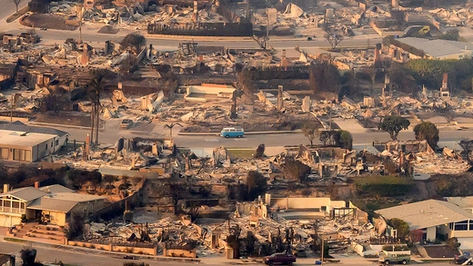 In this aerial view taken from a helicopter, burned homes are seen from above during the Palisades fire near the Pacific Palisades neighborhood of Los Angeles, California on January 9, 2025.