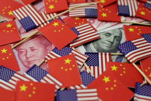 A U.S. dollar banknote featuring American founding father Benjamin Franklin and a China's yuan banknote featuring late Chinese chairman Mao Zedong are seen among U.S. and Chinese flags in this illustration picture taken May 20, 2019. Picture taken May 20, 2019. REUTERS/Jason Lee/Illustration