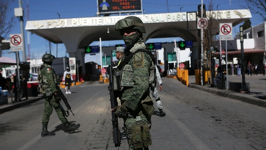 Armed troops guard a border security checkpoint.