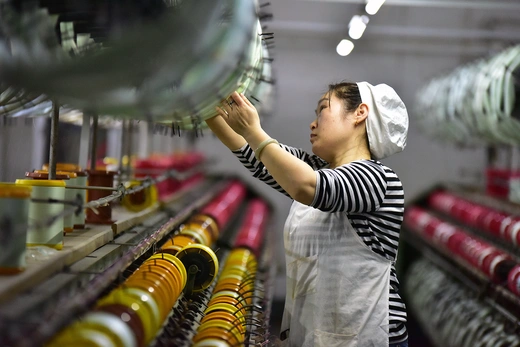  A worker works on the production line of a high-end silk textile enterprise in Fuyang city, East China's Anhui province, March 5, 2025.