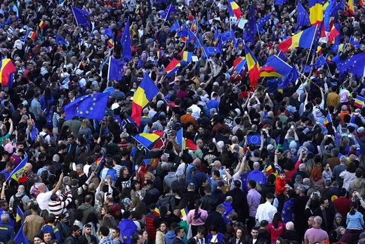 People wave EU and Romanian flags during a pro-EU demonstration in Bucharest, Romania, on March 15, 2025.