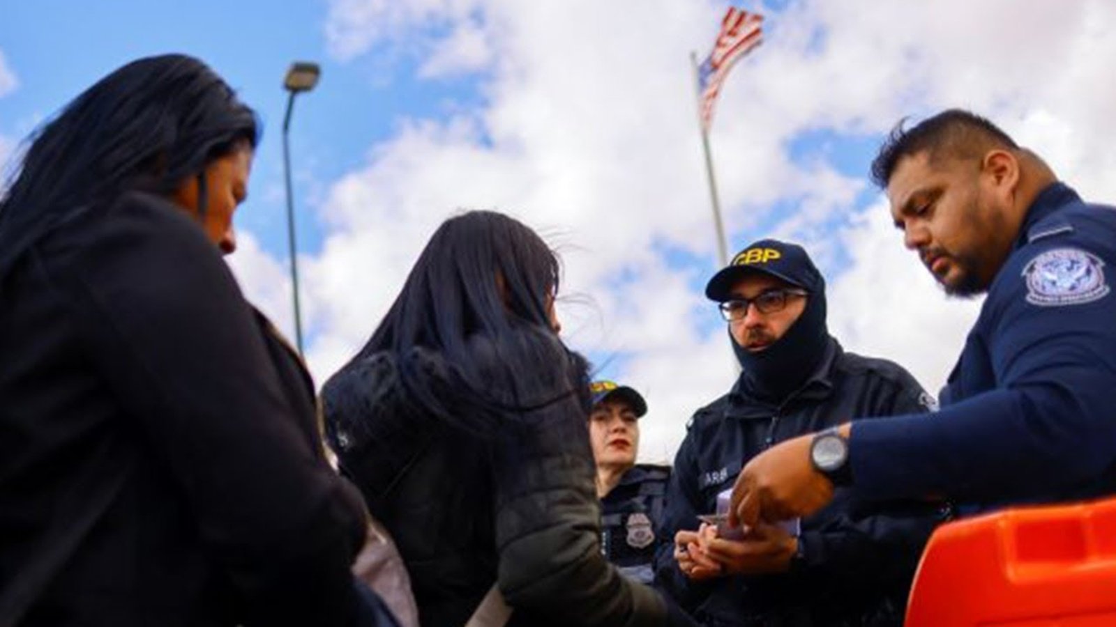 U.S. Customs agent David Gonzalez helps a traveler from Mexico use