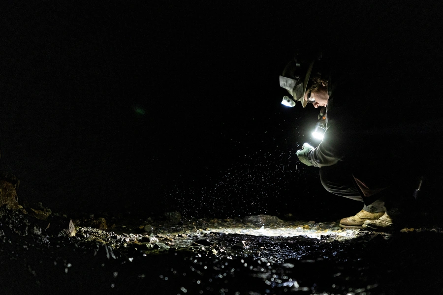 Josh Kluck, a geologist at Jervois Global, holds a flashlight as he looks for a mineral inside a cobalt mining site operated by Jervois Global, west of Salmon, Idaho, U.S. May 16, 2024. REUTERS/Carlos Barria
