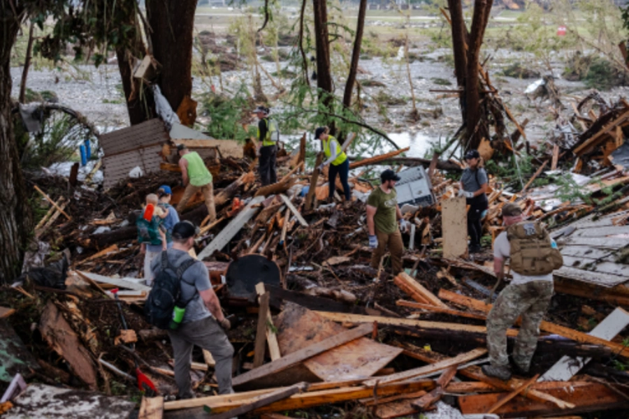 Disaster workers clean up debris from flood
