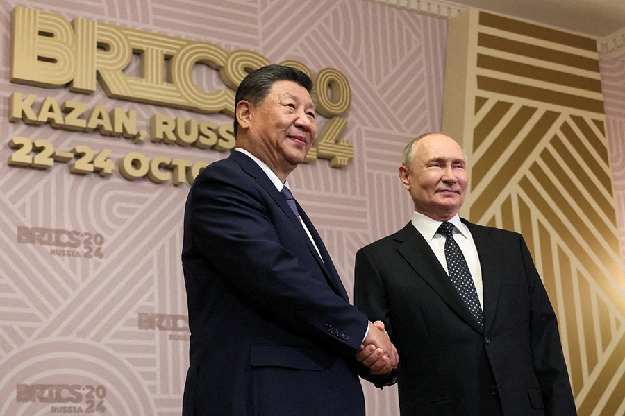 Chinese President Xi Jinping and Russian President Vladimir Putin shake hands at the BRICS summit in Kazan, Russia.