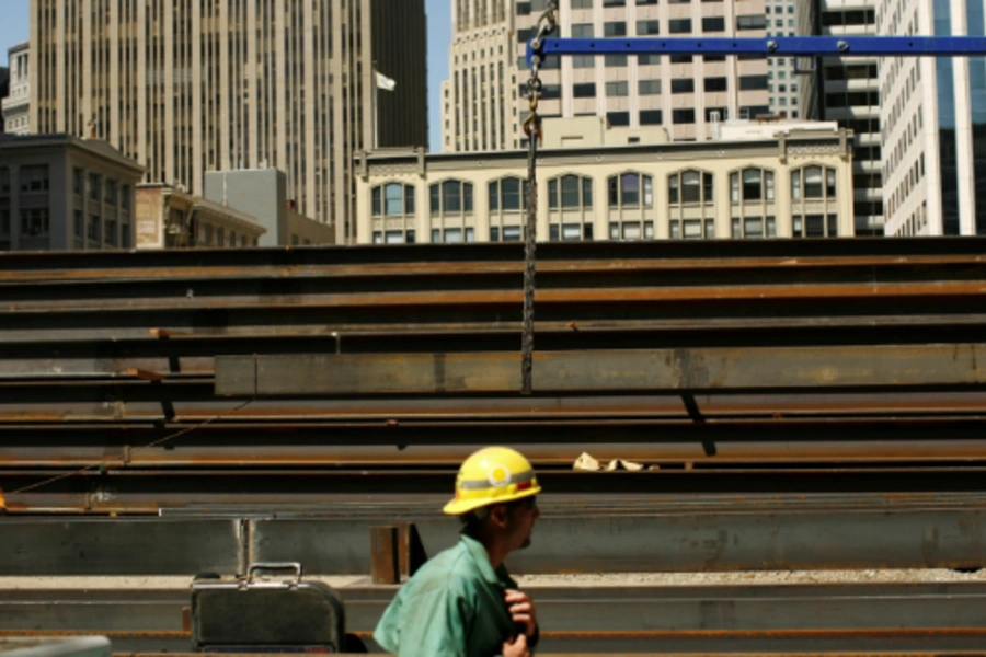 Workers guide steel beams into place at a construction site in San Francisco, California September 1, 2011. Reuters/Robert Galbraith