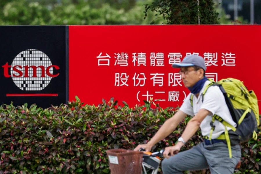 A cyclist waits for traffic lights in front of the logo of the Taiwan Semiconductor Manufacturing Company (TSMC) in Hsinchu, Taiwan, April 16, 2025. Daniel Ceng/Getty Images