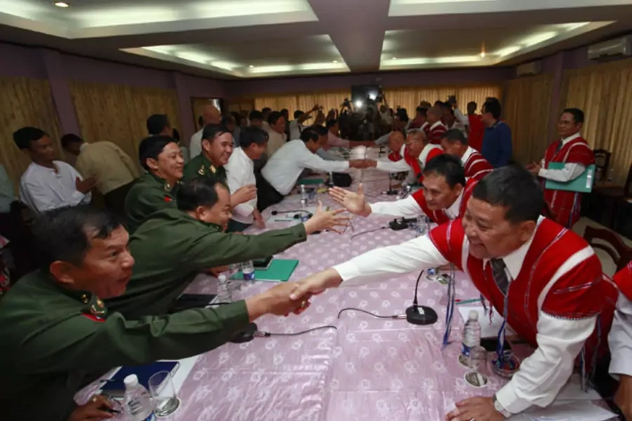 Representatives from Myanmar's government and the Karen National Union (KNU) shake hands during peace talks at Hotel Zwekabin in Pa-an, capital of the Karen State in eastern Myanmar January 12, 2012.
