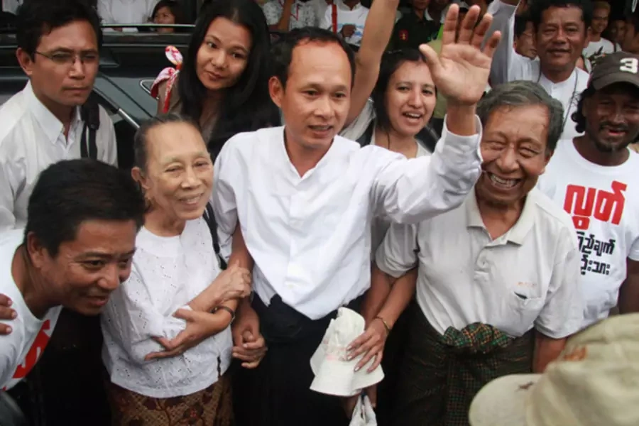 Ko Pyone Cho (C), one of the leaders of a 1988 student uprising, reunites with his family at Yangon International Airport in Yangon January 13, 2012.