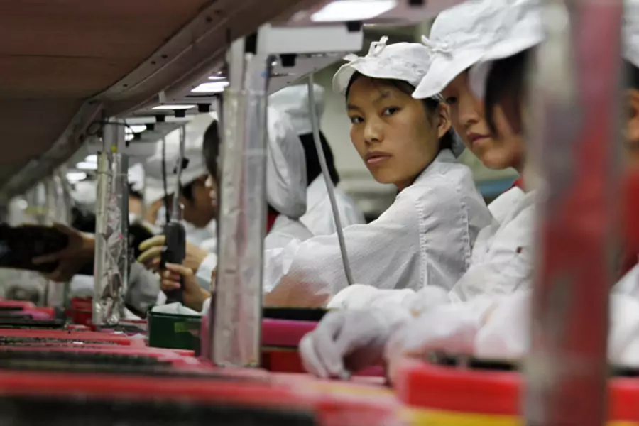 Workers are seen inside a Foxconn factory in the southern Guangdong province of China (Bobby Yip/Courtesy Reuters).